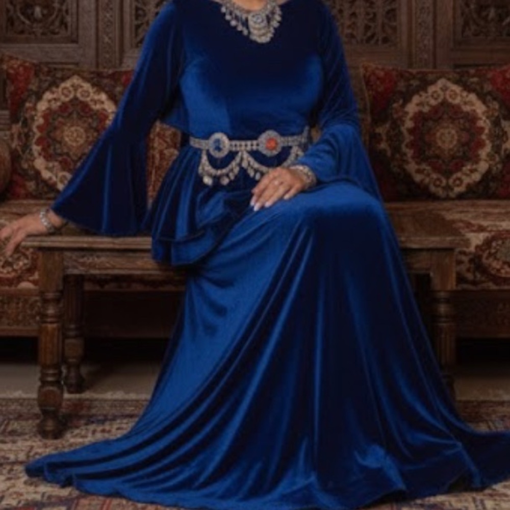 royal blue velvet gown with the traditional headpiece and jewelry: